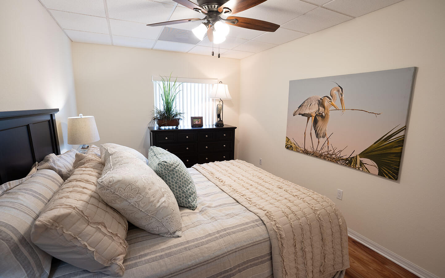 Bedroom with large bed and wide chest of drawers