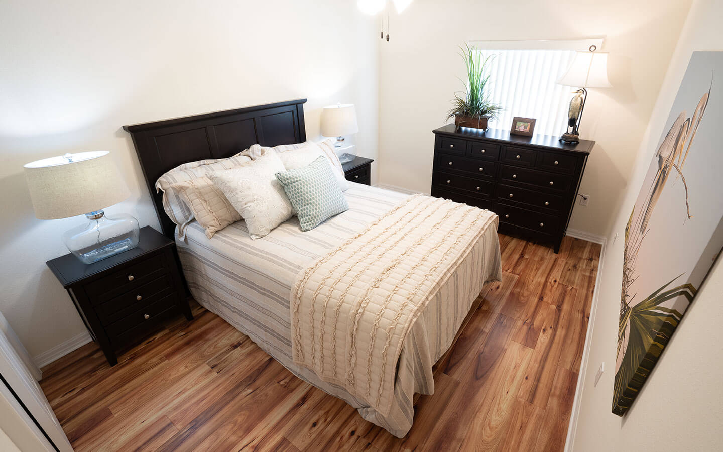 Bedroom with large bed and wide chest of drawers