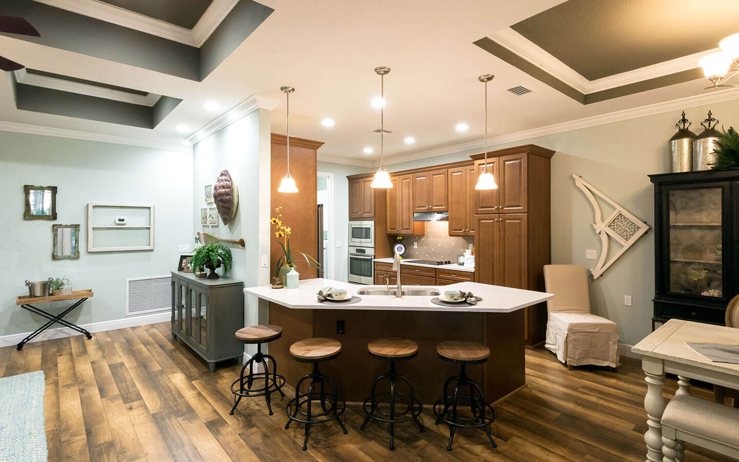 Large kitchen with dark wood cabinets, stove, oven and microwave.