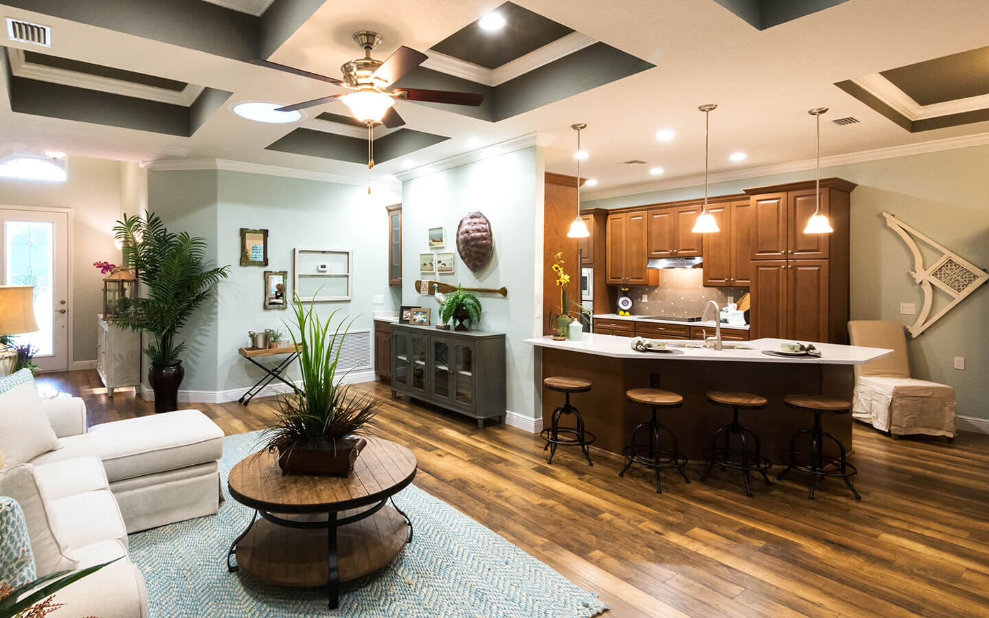 View of the living room, kitchen and home entryway.