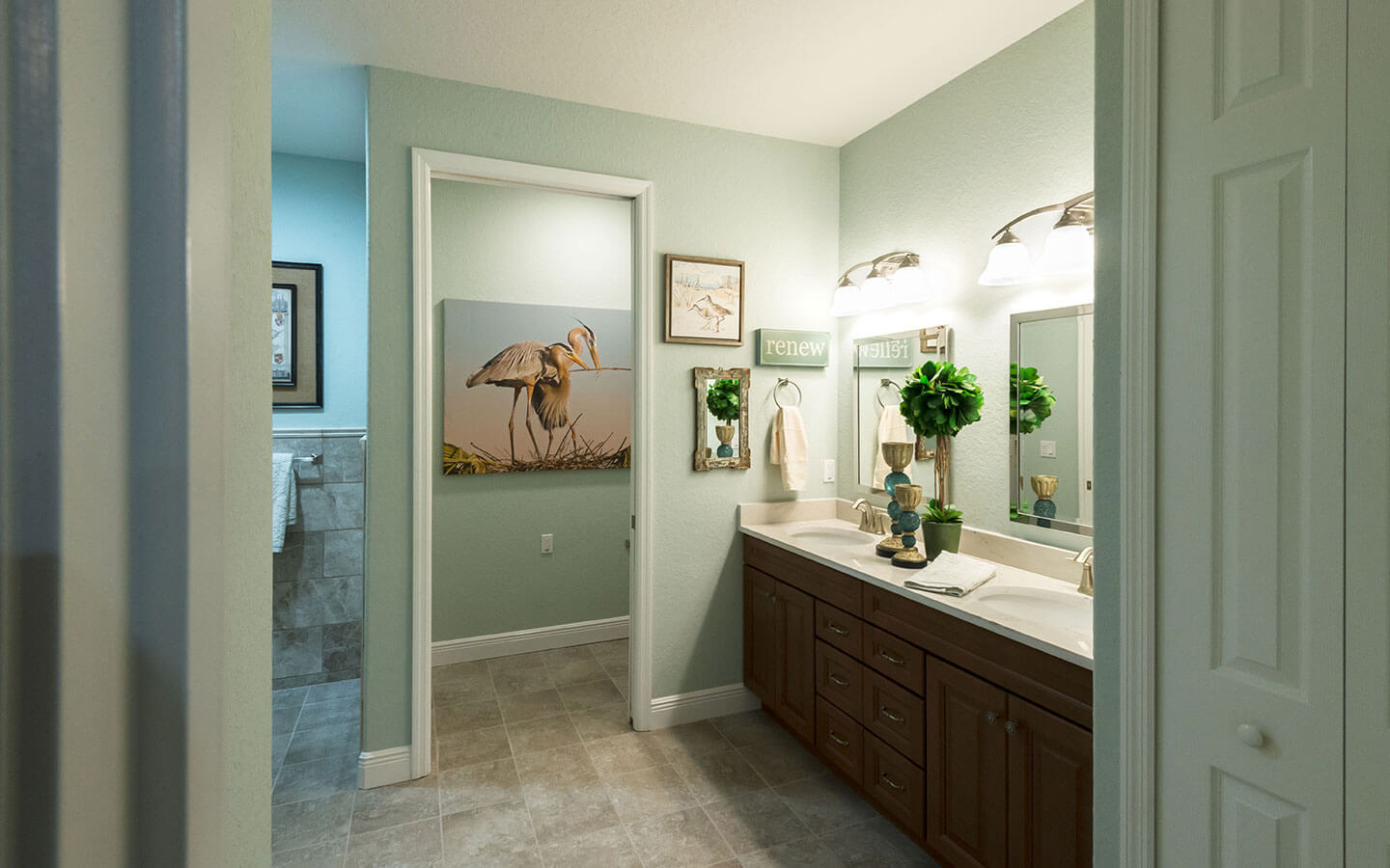 Large two sink counter space with mirrors and hanging lights