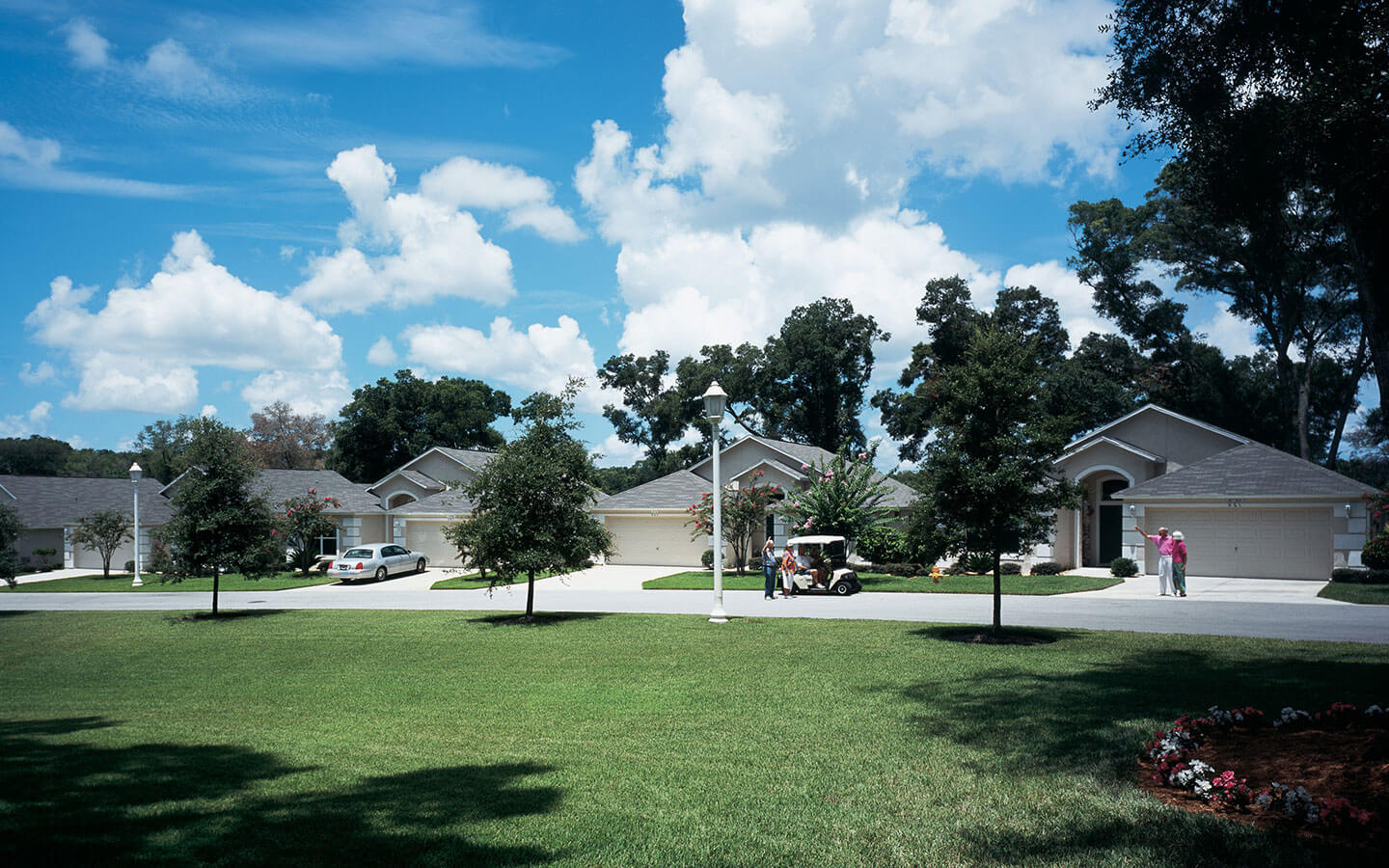 Friends and neighbors waving high as they walk around their neighborhood.